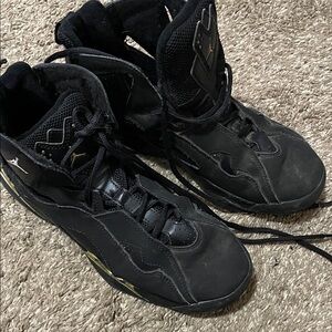 Nike Jordan Black and Gold High-Top Athletic Shoes